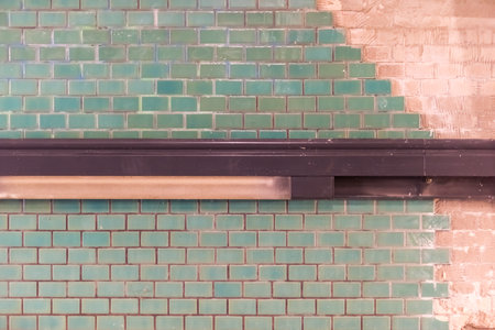 Green tiles on a building site with brown handrailの写真素材