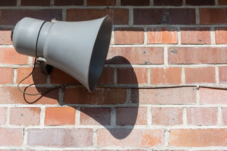 Megaphone in front of an old brick wallの写真素材