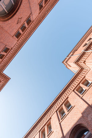 Two modernized brick houses facing each other with blue sky