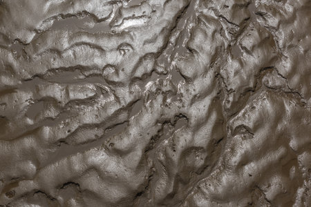 The wet ground at low tide from aboveの写真素材