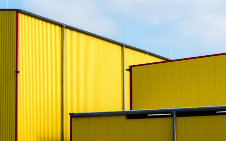 Facades of yellow warehouse with blue skyの写真素材