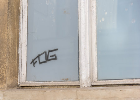 The word fog on frosted glass of an old window paneの写真素材