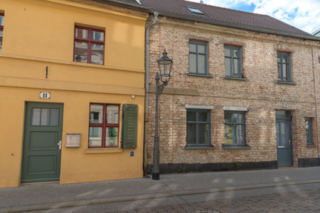 Two houses in one street, one with new and one with old facadeの写真素材
