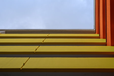 Balconies in yellow and red with a view upwards in the city of berlinの写真素材