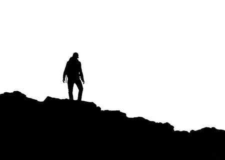 A silhouette of a wanders on top of the mountainの写真素材