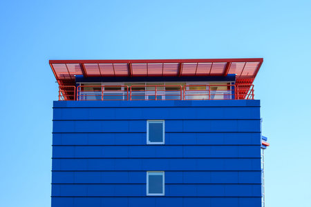 Blue office building with cloudless background in sunshine