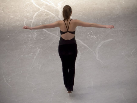 This is a shot of an ice skater posing from the back.の写真素材