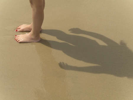 This a shot of  young feet on the sand at the beach.の写真素材