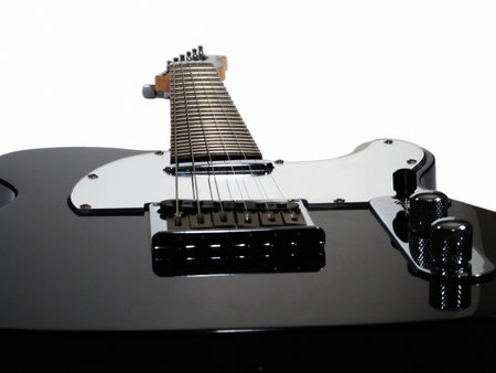 A silhouette of a black electric guitar with a clipping path.