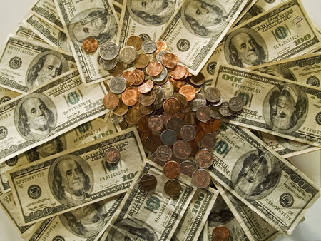 A collage of change and 100 dollar bills.の写真素材