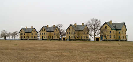 A row of turn of the 20th century yellow brick homes was part of the Barracks of Fort Hancock on Sandy Hook, along the Jersey shore.の写真素材