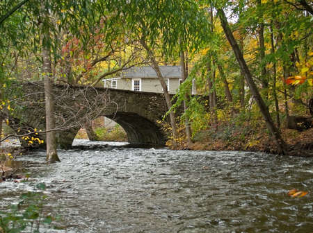An old stone bridge over a creek in the Pocono Mountains of Pennsylvania.の写真素材