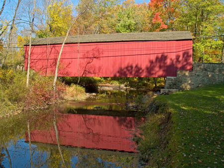 An Autumn view of the historic Pine Valley Covered Bridge located in Bucks County, Pennsylvania.