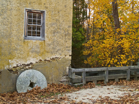An old millstone and the wall of the old grist mall is part of the historic Batsto Village in South Jersey.の写真素材