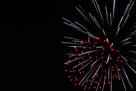 A detailed shot of bright colorful fireworks in the night sky.の写真素材