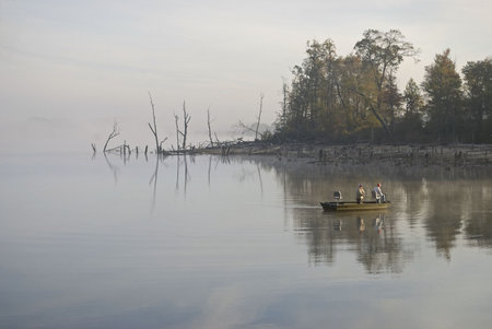 Fisherman out on the Manasquan Resevoir early on this foggy Autumn morning.の写真素材
