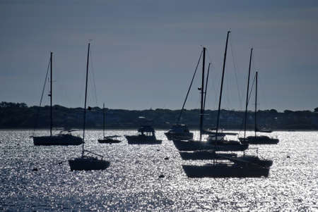 Silhouette of boats in the sparkling water  in Hyannis Port on Cape Cod in Massachusetts.の写真素材