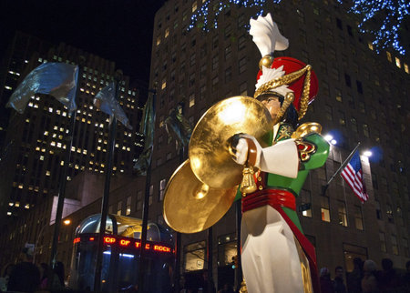 NEW YORK-DEC 2 2011: A Large toy drummer statue and the holiday lights in Rockefeller Center on...