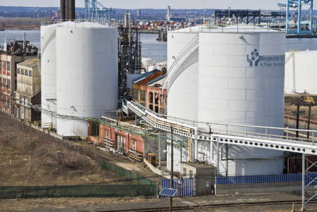 BAYONNE, NJ/USA-MARCH 9: Oil storage tanks and old factories along Newark Bay on March 9, 2012 in Bayonne, NJ. The location is a center for oil storage and international shipping.のeditorial素材