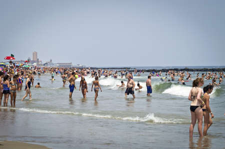 AVON, NEW JERSEY/USA  JULY 7: Big crowds of sunbathers seek relief from the week long heatwave enjoying the surf on July 7, 2012 at the beach in Avon NJ.のeditorial素材