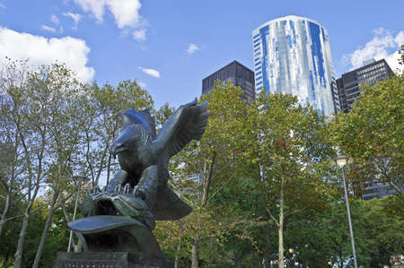 "Navy Memorial Eagle"  NEW YORK - SEPTEMBER 24: The US Navy Memorial Eagle in Battery Park and surrounding modern architecture of lower Manhattan on September 24,2012. The park commemorates sailors killed during World War 2.のeditorial素材