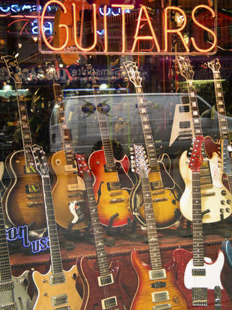 "Guitar Store" A guitar store window display in a music store in New York City.のeditorial素材