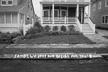 BELMAR, NEW JERSEY/USA â OCTOBER 30: A message on a boardwalk plank blocks away from the ocean after Hurricane Sandy on October 30 2012 in Belmar, NJ.のeditorial素材