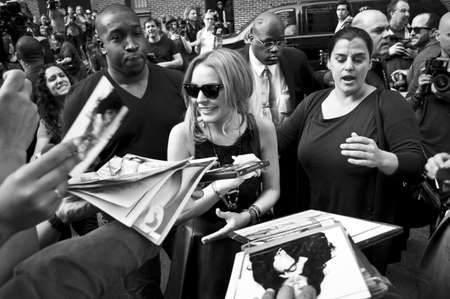 NEW YORK - APRIL 9: Lindsay Lohan greets fans after her David Letterman appearance outside the Ed Sullivan Theater on April 9, 2013 in Manhattan.のeditorial素材
