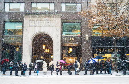 NEW YORK-JANUARY 21  Commuters waiting for the bus along 42nd St  during Winter Storm Janus on January 21, 2014 in Manhattan のeditorial素材