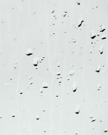 Raindrops on a neutral gray background の写真素材