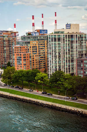 NEW YORK-JULY 29-High rise apartments and the Con Ed smoke stacks along the the East River on Roosevelt Island on July 29 2014 in New York City のeditorial素材