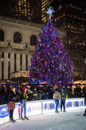 NEW YORK-DECEMBER 10: Ice skaters enjoy the falling snow by the Bryant Park Christmas tree on...