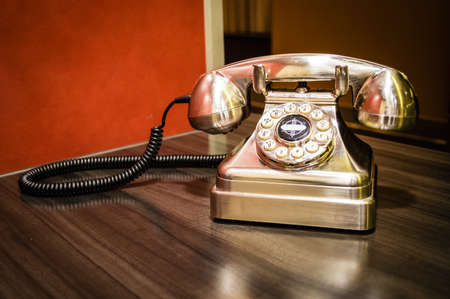 A metallic old fashioned landline telephone.の写真素材