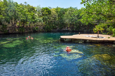 PLAYA DEL CARMEN,MEXICO-MAY 23- Tourists swimming in a cenote at a resort on May 23 2015 in Playa del Carmen in Mexico.のeditorial素材