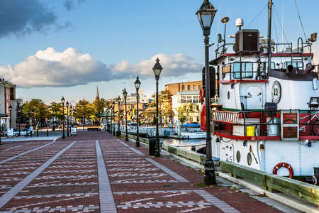 BALTIMORE-OCTOBER 18: A view of a pier with a tug boat in Fells Point, a popular tourist destination on October 18 2015 in Baltimore.のeditorial素材