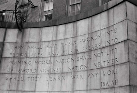 A black and white film photograph of a famous Old Testament Bible quote on an East Side wall in Manhattan.の写真素材