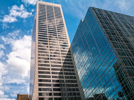 Steel and glass skyscrapers reflecting the sky in Manhattan.
