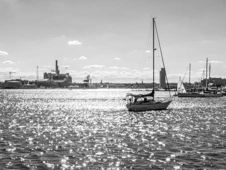 Baltimore, Maryland, USA - April 23, 2016: A black and white view of sailboats and the city off in the distance  from Canton Waterfront Park in Baltimore Maryland.のeditorial素材