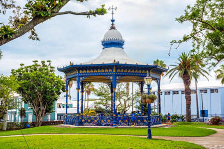 HAMILTON,BERMUDA, MAY 25 - Children play wearing school uniforms by the old gazebo in Victoria Park on May 25 2016 in Hamilton,Bermuda.のeditorial素材