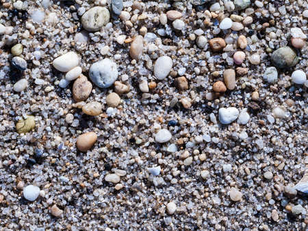 Small rounded stones smoothed by the sea along the shoreline in Sandy Hook New Jersey.の写真素材