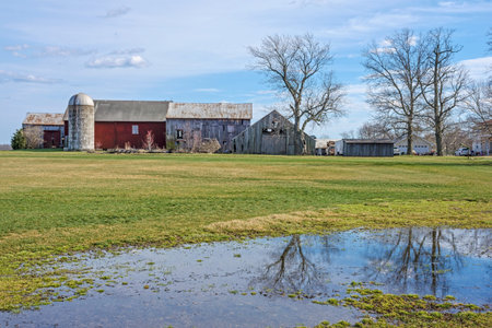 An old fashioned farm scene with a reflecting puddle in rural Central New Jersey.の写真素材