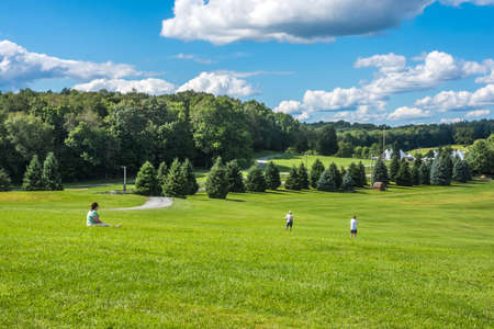 BETHEL, NEW YORK - August 13 - People enjoy a nice Summer day and historic view on the actual concert grounds of the Woodstock Festival on August 13, 2017 in Bethel NY.のeditorial素材