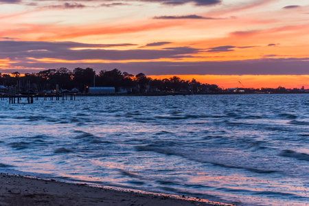Sunset with brilliant colors over the surf in Atlantic Highlands New Jersey.