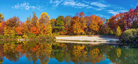 The swimming beach surrounded by Autumn leaves in Schooly's Mountain Park in Washington Township New Jersey.の写真素材