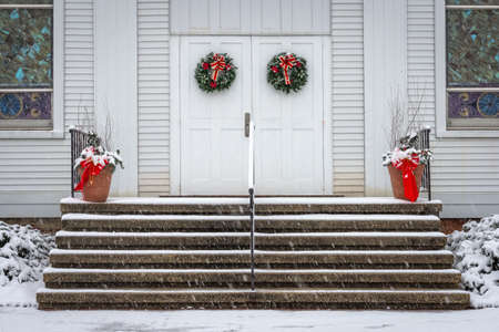 A welcoming snowy view of the Christmas decorations on this old church in Englishtown New Jersey.の写真素材