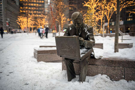 NEW YORK-JANUARY 4: The businessman statue with fresh snow after the bomb cyclone snow storm in Zuccotti Park on January 4 2018 in lower Manhattan.のeditorial素材