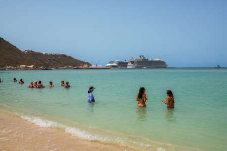 PHILLIPSBURG, ST. MARTEEN - JULY 11 - Tourists enjoy the calm turquoise colored water within view of their cruise ships on July 11 2018 in Phillipsburg, St. Marteen.のeditorial素材