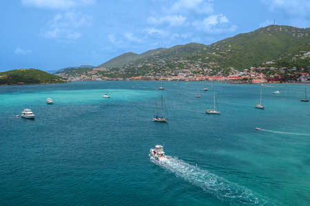 ST THOMAS, US VIRGIN ISLANDS - Turquoise colored water with sailboats and homes along the mountainside in St Thomas of the US Virgin Islands.の写真素材