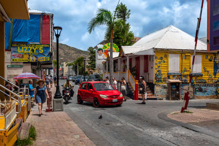 PHILLIPSBURG, ST. MARTEEN - JULY 11 - A colorful street scene with tourists and colorful architecture along the main street on July 11 2018 in Phillipsburg, St. Marteen.のeditorial素材
