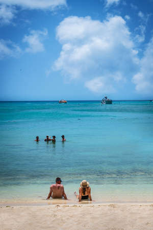 PRINCESS CAYS, BAHAMAS - JULY 8 - A couple relaxes on the beach on July 8 2018 on the small island Princess Cays in the Bahamas.のeditorial素材